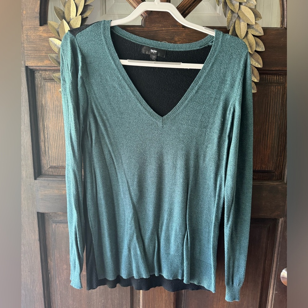 Teal and black sweater. Teal in the from. Black in the back. Vneck and comfy!